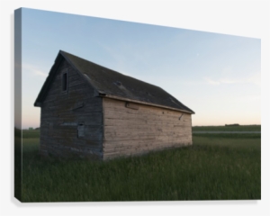 A Wooden Shed In The Middle Of A Grass Field Canvas