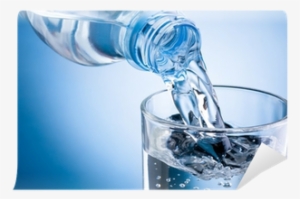 Pouring Water From Bottle Into Glass On Blue Background - Early Morning Drinking Water