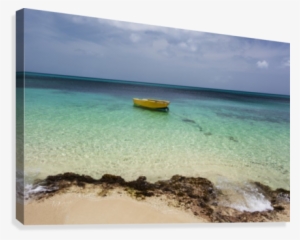 A Lone Boat In The Turquoise Water Off A Tropical Island