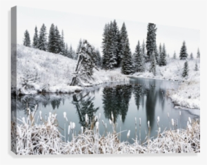 An Open Pond In The Winter With Snow Covered Hilly