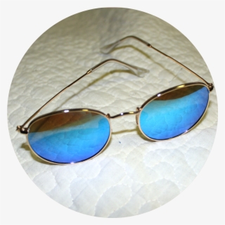 A Pair Of Gold Sunglasses With Blue Lenses Sit On White