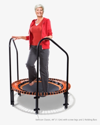 A Woman Of About 70 Exercising With Support Hand Bars - Old People On Trampoline
